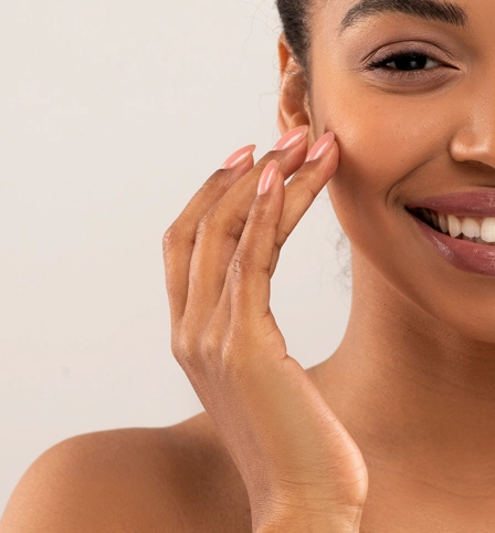 A lady touching her face.