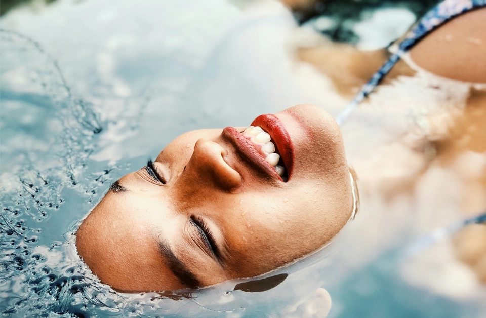Someone laying in a pool of water with fresh skin.